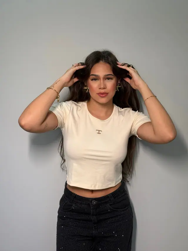 Cropped TBull Estelle off white em malha canelada, em foto de estúdio.